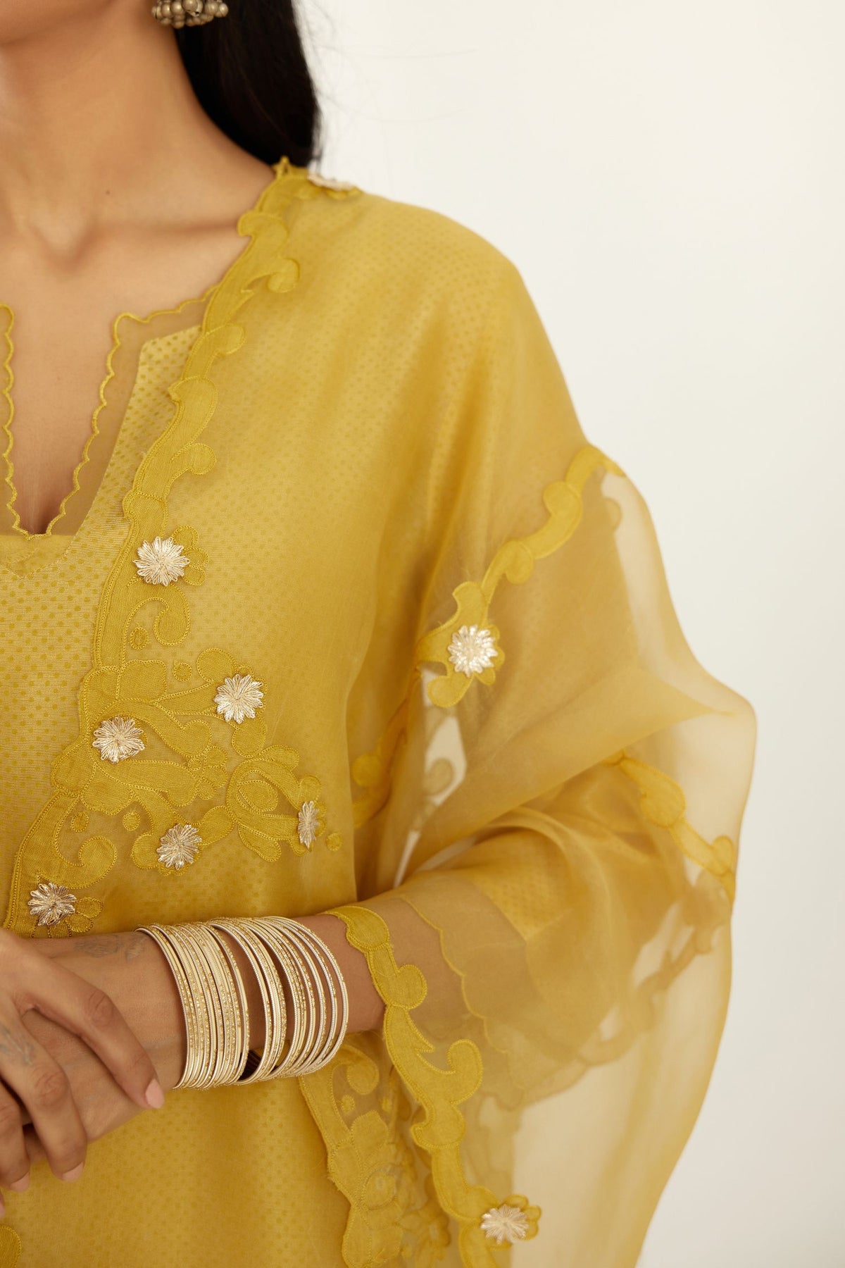 Yellow silk chanderi hand block printed straight kurta set, highlighted with scalloped organza at edges.
