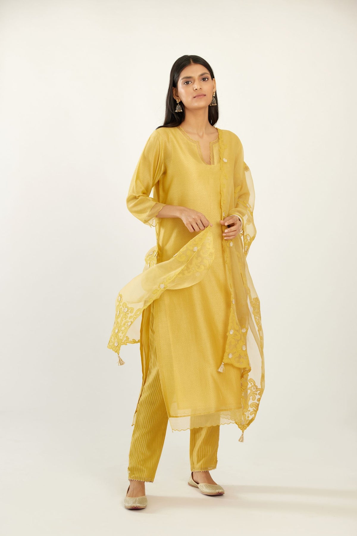 Yellow silk chanderi hand block printed straight kurta set, highlighted with scalloped organza at edges.