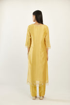 Yellow silk chanderi hand block printed straight kurta set, highlighted with organza and gota embroidered flower at edges.