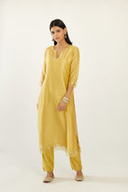Yellow silk chanderi hand block printed straight kurta set, highlighted with organza and gota embroidered flower at edges.