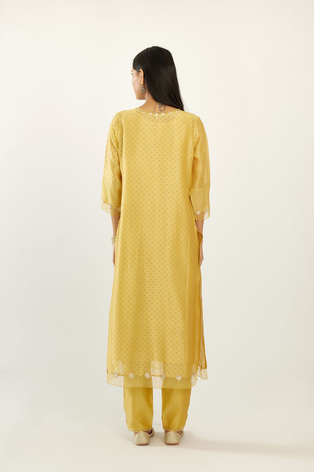 Yellow hand block printed silk chanderi kurta set with concealed button placket neckline, Highlighted with gota flower and scalloped organza at edges