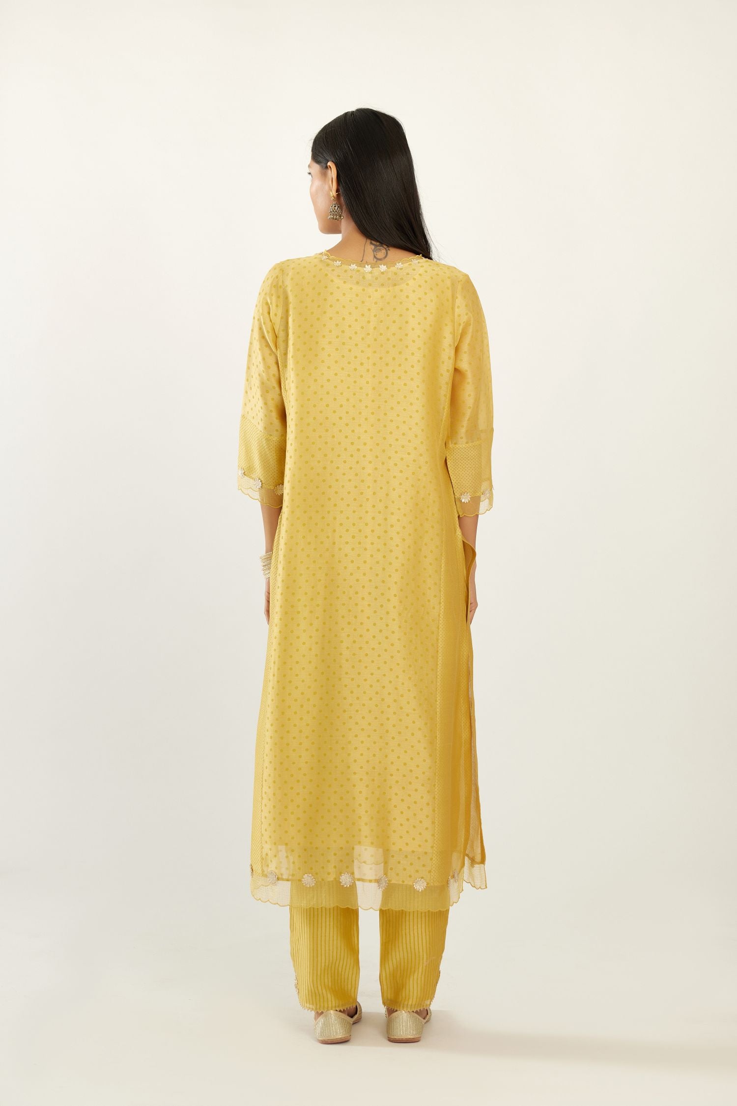 Yellow hand block printed silk chanderi kurta set with concealed button placket neckline, Highlighted with gota flower and scalloped organza at edges