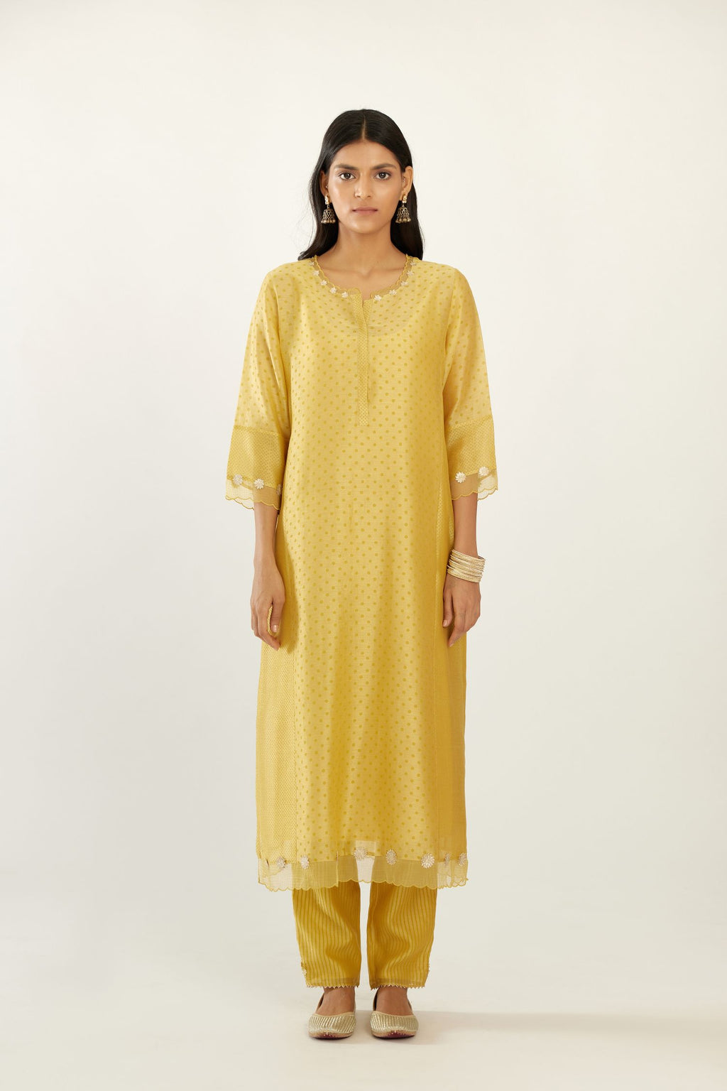 Yellow hand block printed silk chanderi kurta set with concealed button placket neckline, Highlighted with gota flower and scalloped organza at edges
