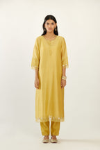 Yellow hand block printed silk chanderi kurta set with concealed button placket neckline, Highlighted with gota flower and scalloped organza at edges