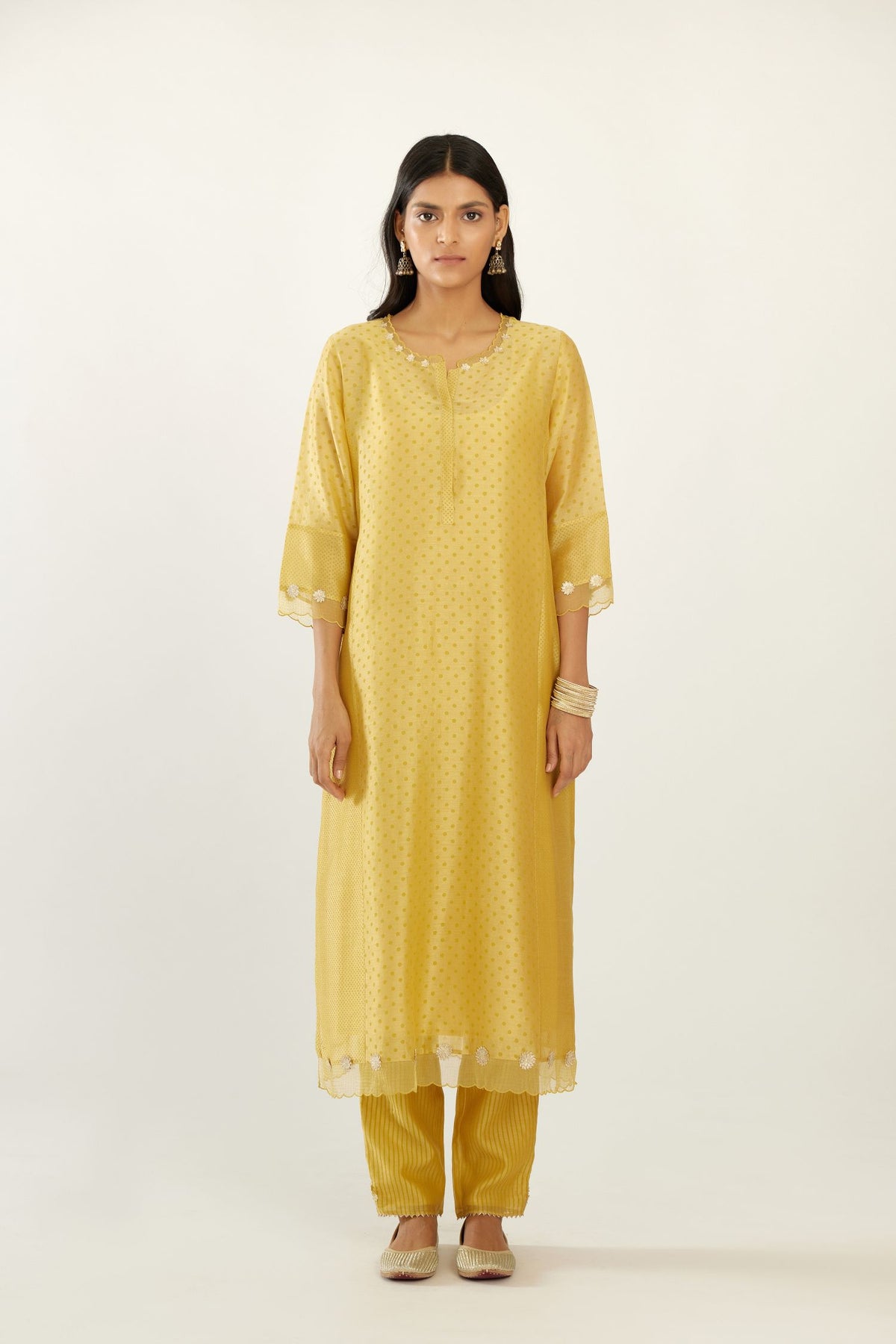 Yellow hand block printed silk chanderi kurta set with concealed button placket neckline, Highlighted with gota flower and scalloped organza at edges