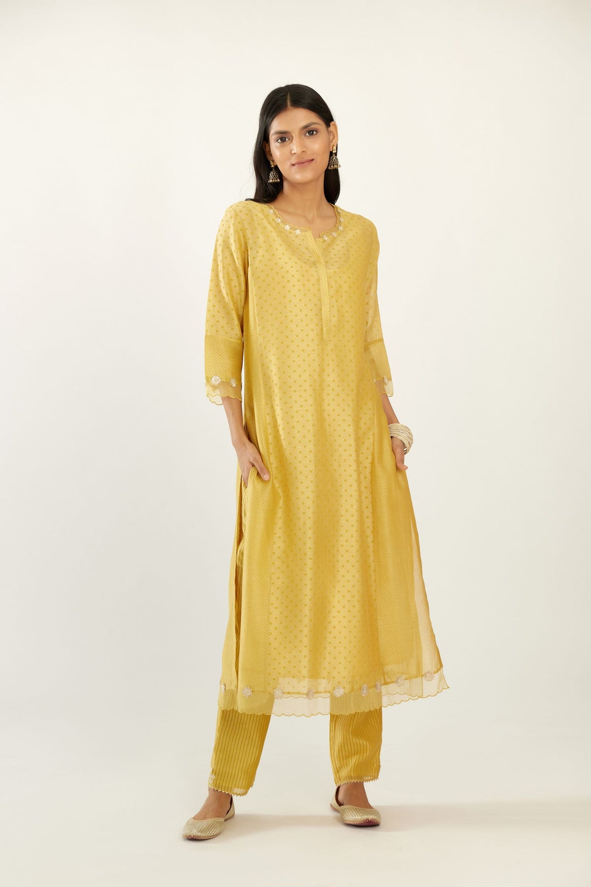 Yellow hand block printed silk chanderi kurta set with concealed button placket neckline, Highlighted with gota flower and scalloped organza at edges