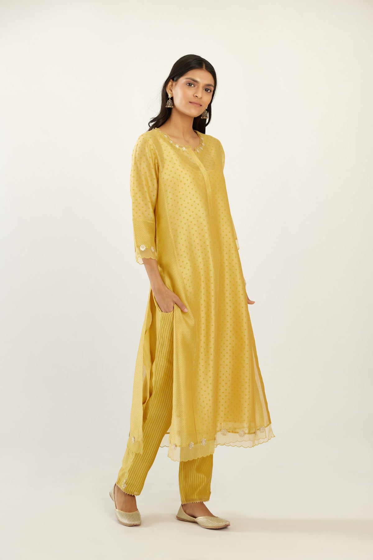Yellow hand block printed silk chanderi kurta set with concealed button placket neckline, Highlighted with gota flower and scalloped organza at edges
