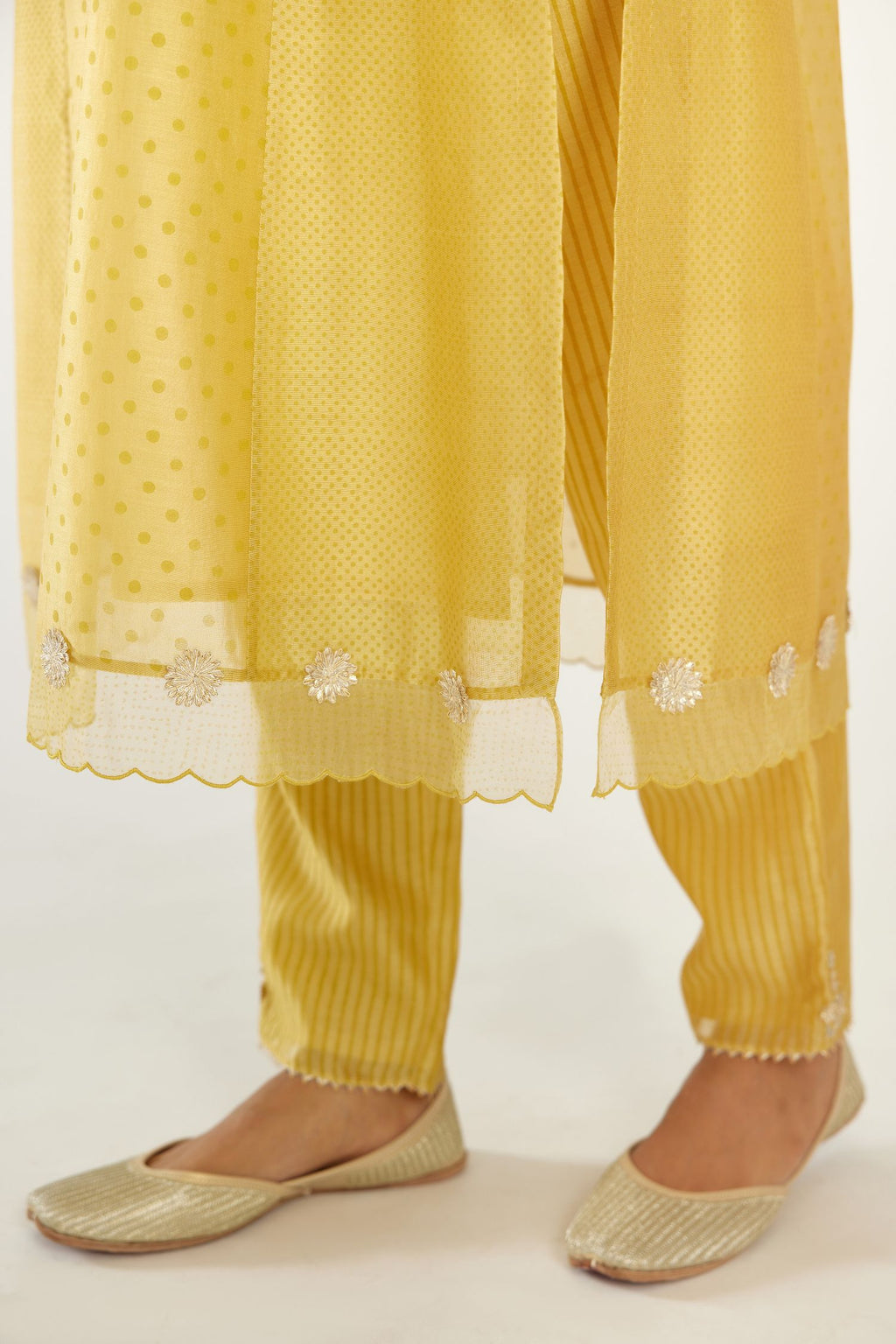 Yellow hand block printed silk chanderi kurta set with concealed button placket neckline, Highlighted with gota flower and scalloped organza at edges
