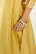 Yellow hand block printed silk chanderi kurta set with concealed button placket neckline, Highlighted with gota flower and scalloped organza at edges