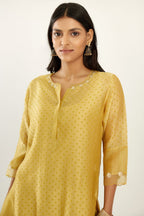 Yellow hand block printed silk chanderi kurta set with concealed button placket neckline, Highlighted with gota flower and scalloped organza at edges