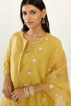 Yellow hand block printed silk chanderi kurta set with concealed button placket neckline, Highlighted with gota flower and scalloped organza at edges
