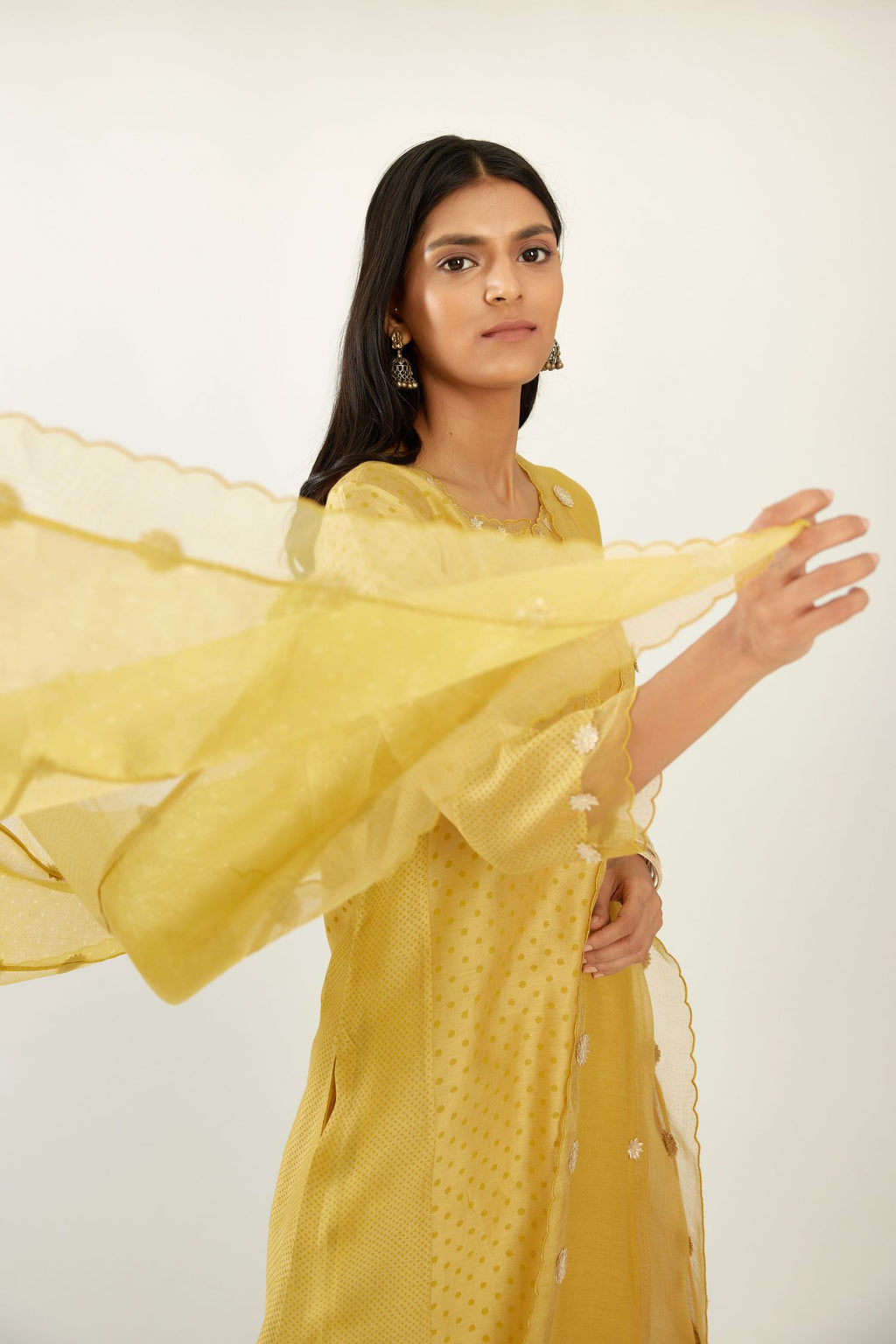 Yellow hand block printed silk chanderi kurta set with concealed button placket neckline, Highlighted with gota flower and scalloped organza at edges