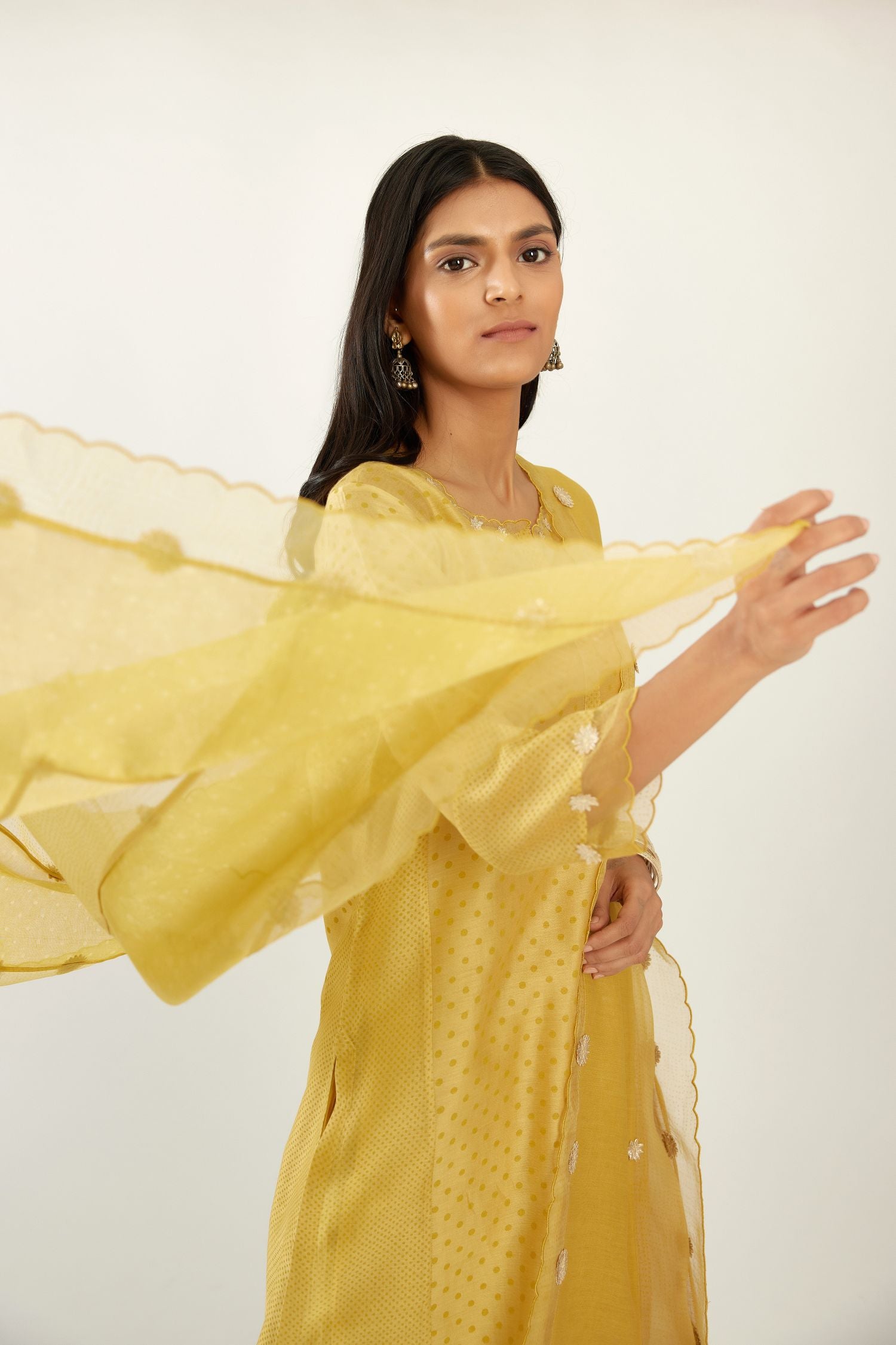 Yellow hand block printed narrow dupatta, highlighted with all-over gota flower and organza scalloped edges.