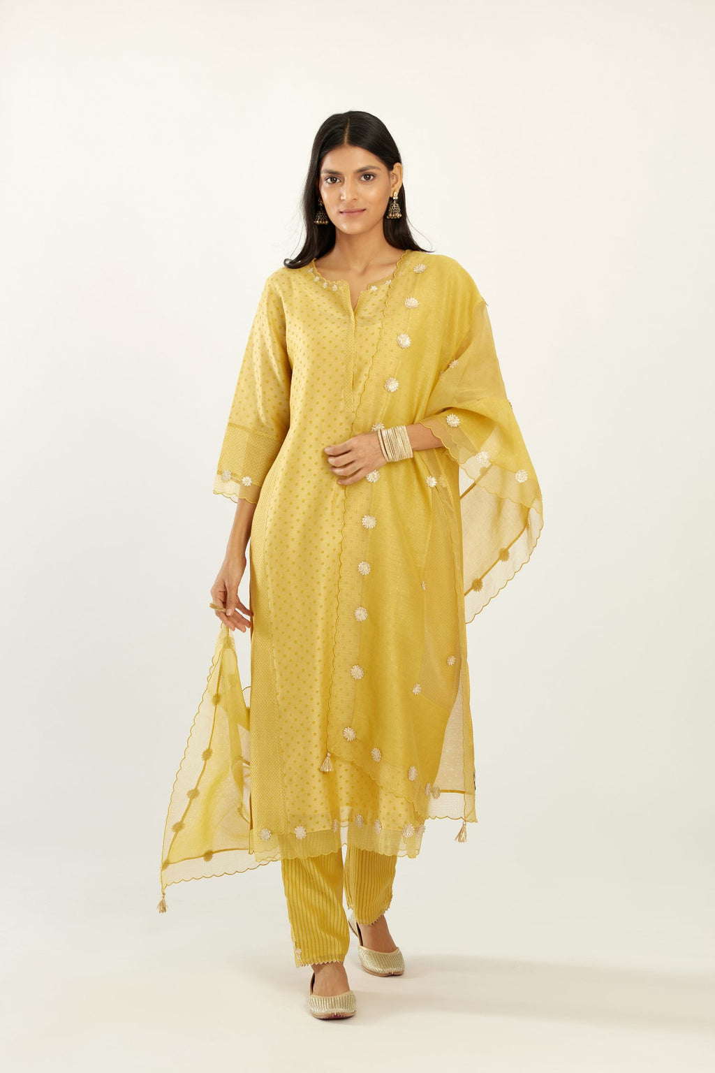 Yellow hand block printed silk chanderi kurta set with concealed button placket neckline, Highlighted with gota flower and scalloped organza at edges