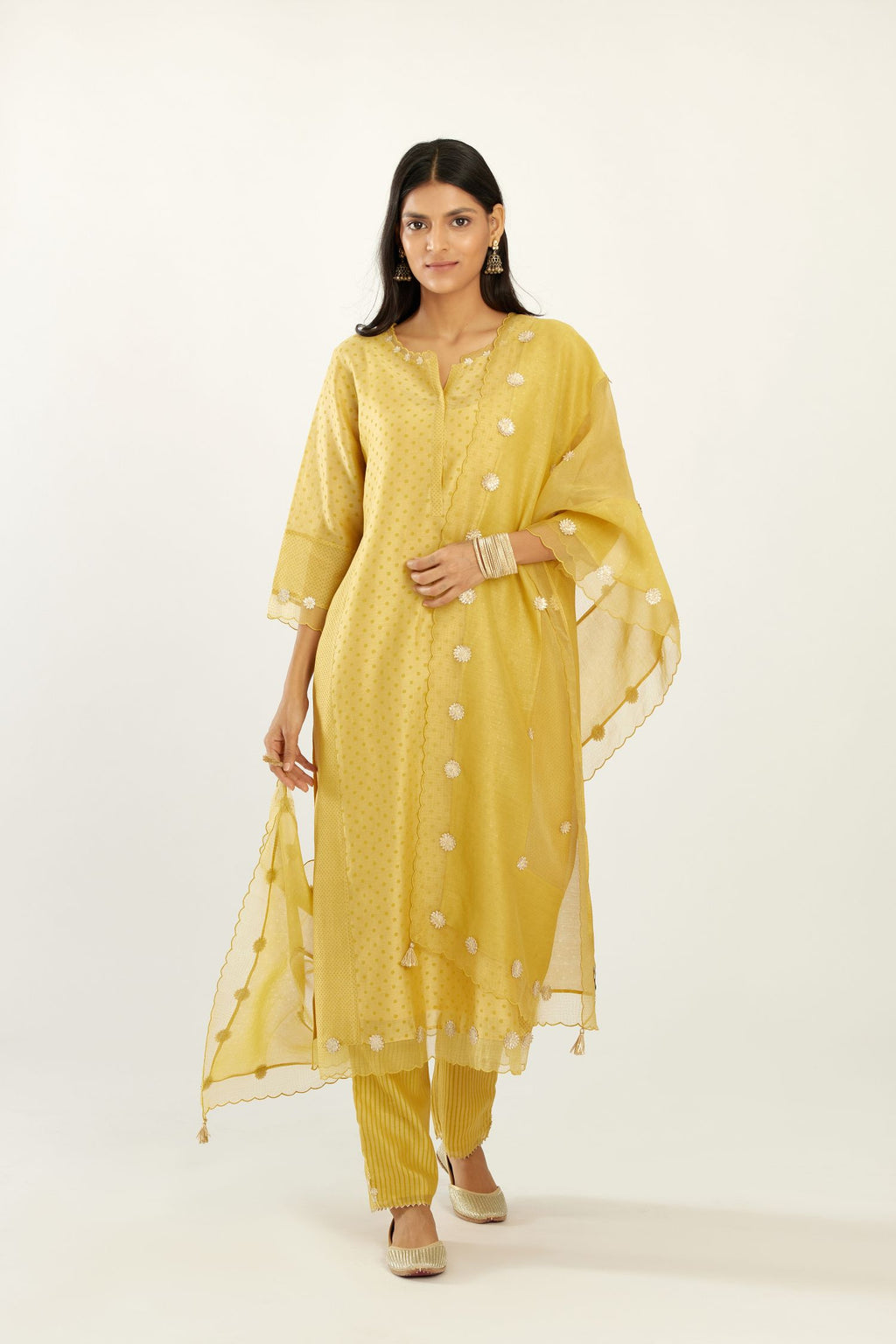 Yellow hand block printed narrow dupatta, highlighted with all-over gota flower and organza scalloped edges.