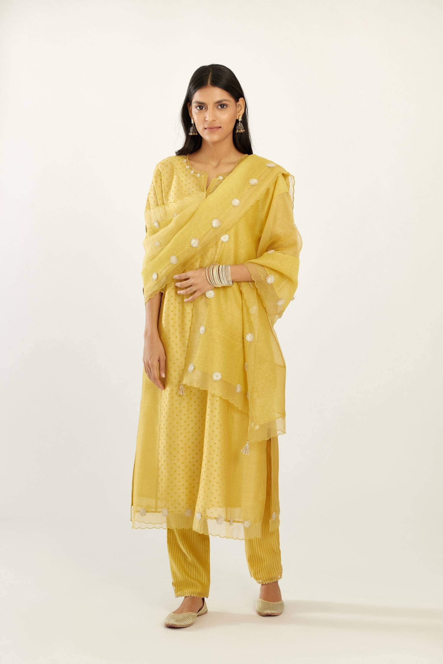 Yellow hand block printed narrow dupatta, highlighted with all-over gota flower and organza scalloped edges.