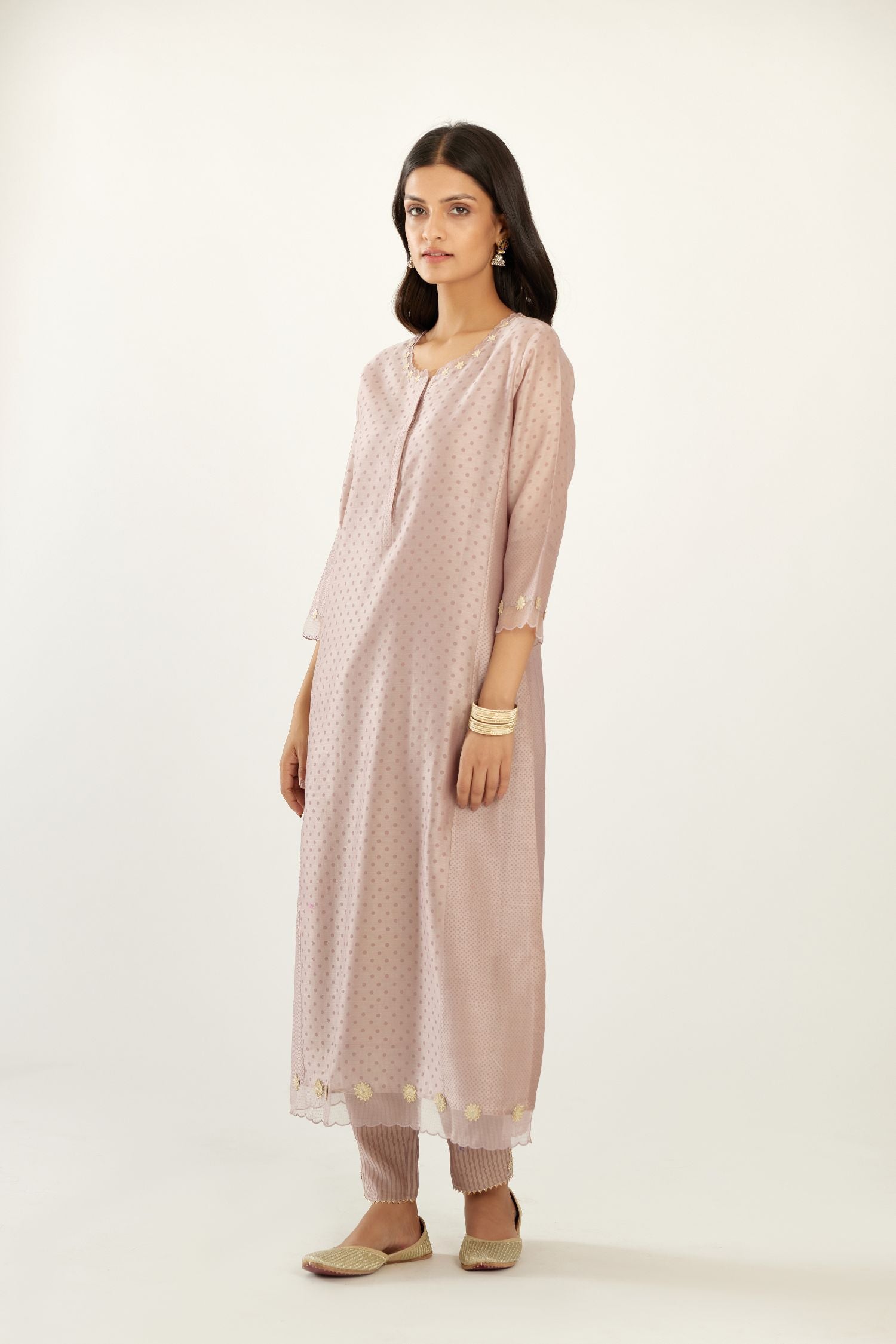 Lilac hand block printed silk chanderi kurta set with concealed button placket neckline, Highlighted with gota flower and scalloped organza at edges.