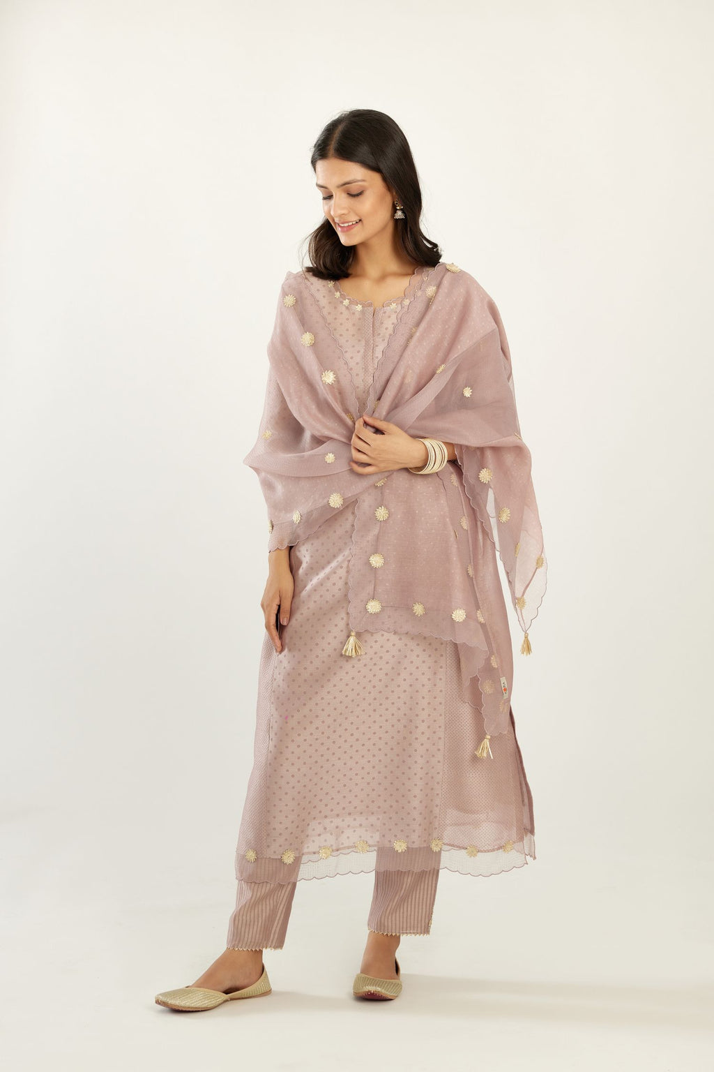 Lilac hand block printed silk chanderi kurta set with concealed button placket neckline, Highlighted with gota flower and scalloped organza at edges.