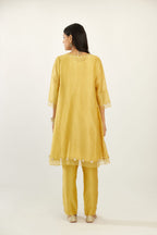 Yellow hand block printed silk chanderi easy fit short kurta set, highlighted with gota flower and scalloped organza at edges.