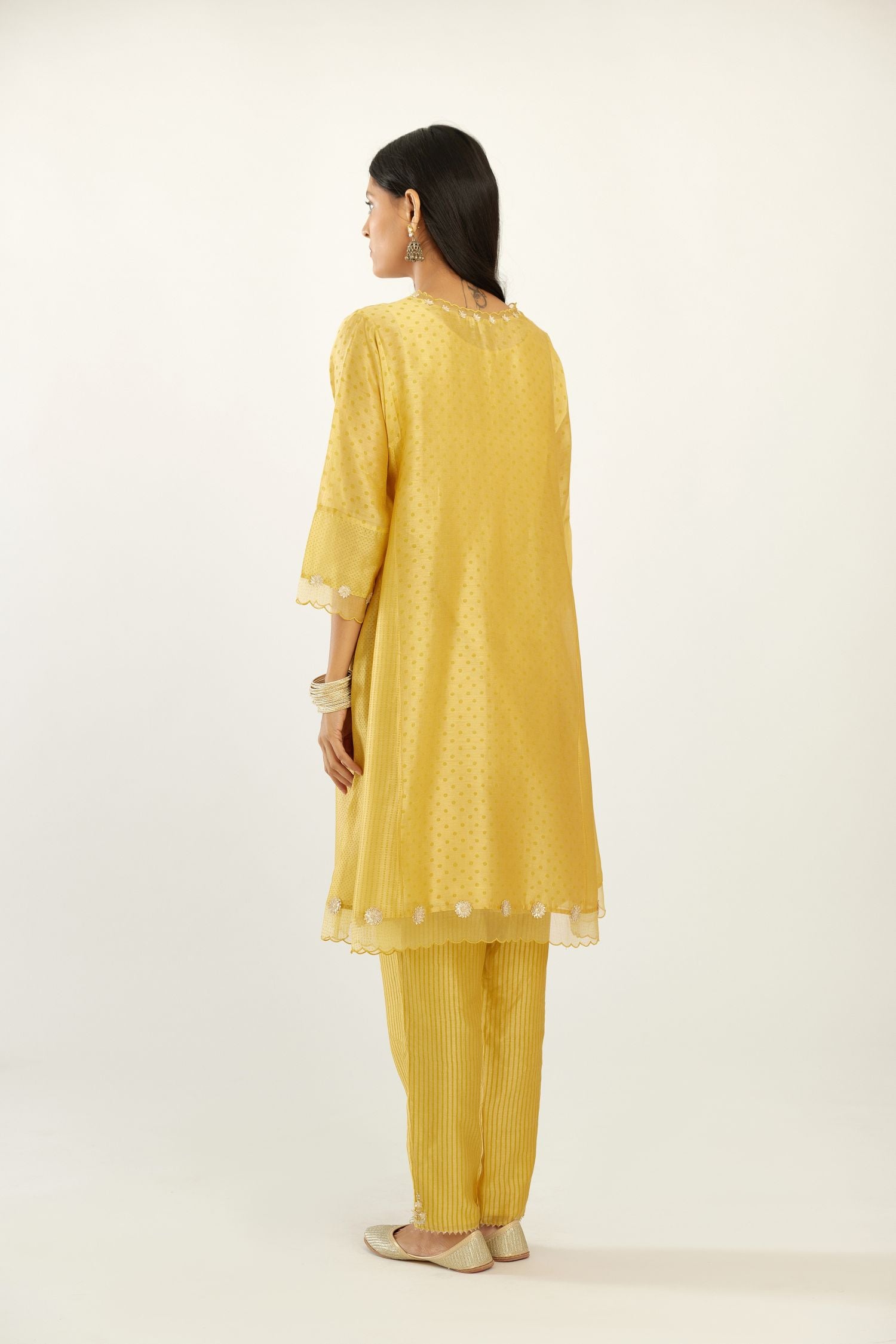 Yellow hand block printed silk chanderi easy fit short kurta set, highlighted with gota flower and scalloped organza at edges.
