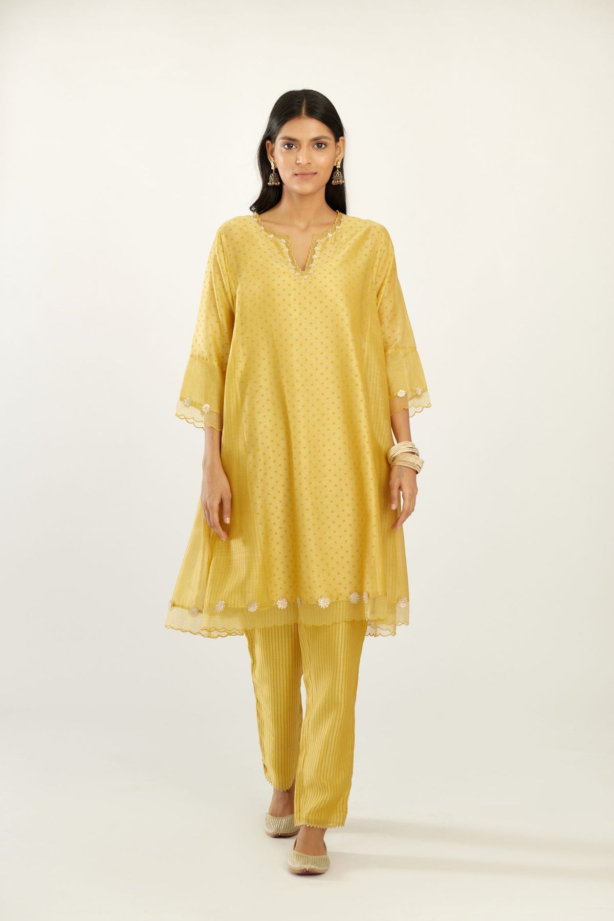 Yellow hand block printed silk chanderi easy fit short kurta set, highlighted with gota flower and scalloped organza at edges.