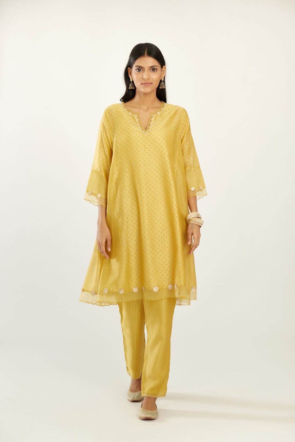 Yellow hand block printed silk chanderi easy fit short kurta set, highlighted with gota flower and scalloped organza at edges.