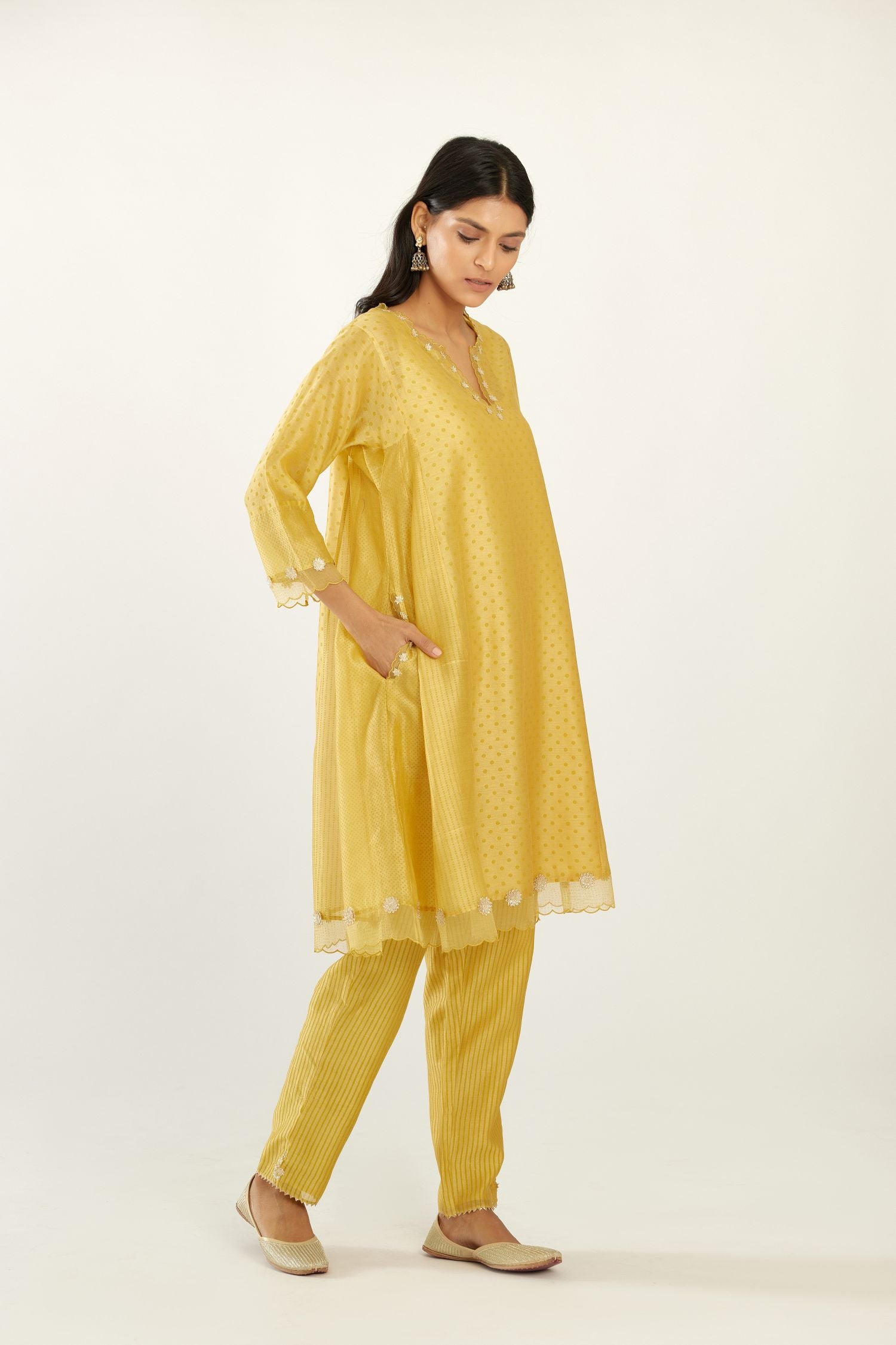 Yellow hand block printed silk chanderi easy fit short kurta set, highlighted with gota flower and scalloped organza at edges.