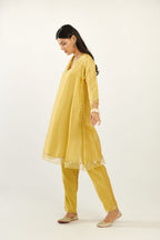 Yellow hand block printed silk chanderi easy fit short kurta set, highlighted with gota flower and scalloped organza at edges.