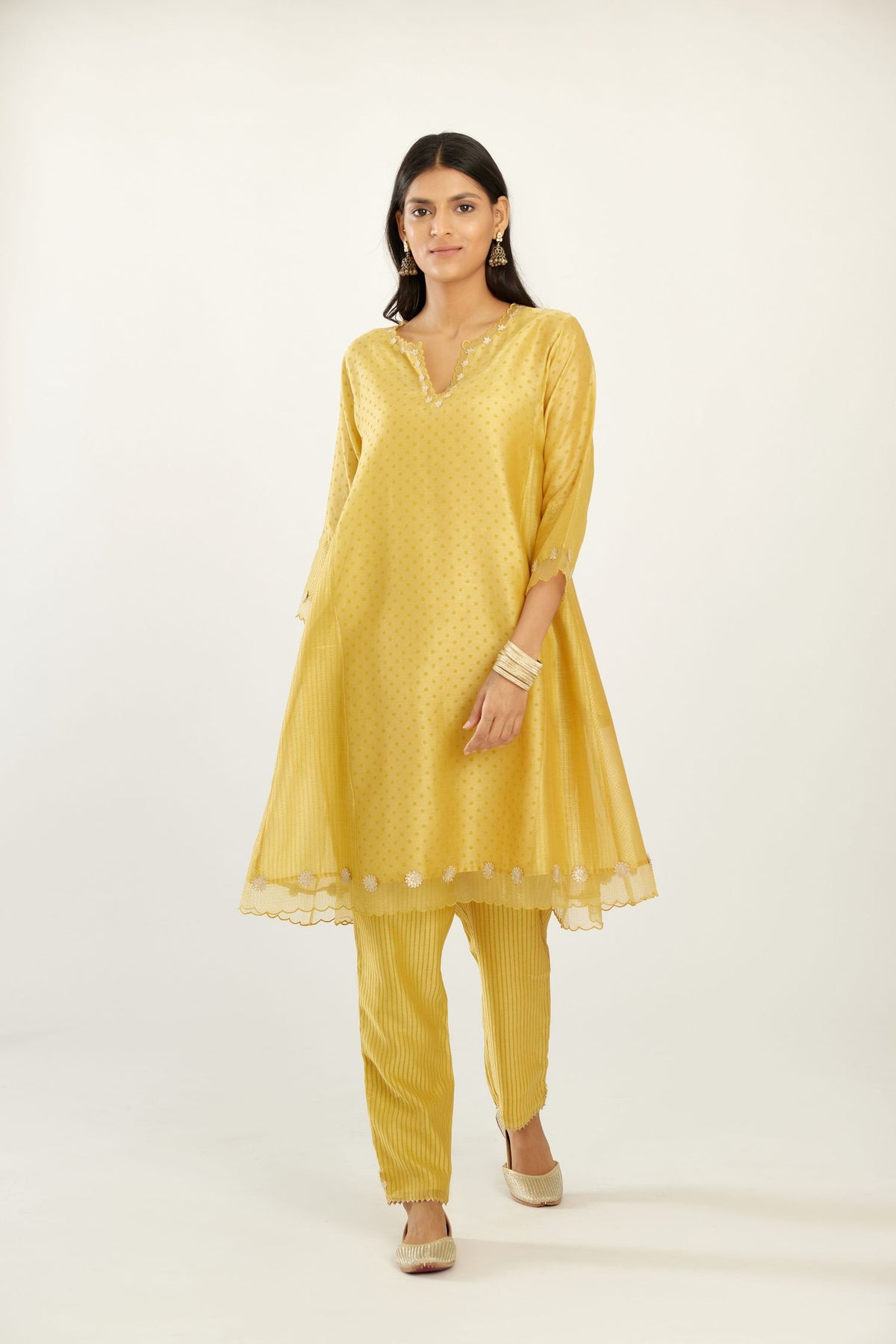 Yellow hand block printed silk chanderi easy fit short kurta set, highlighted with gota flower and scalloped organza at edges.