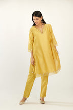 Yellow hand block printed silk chanderi easy fit short kurta set, highlighted with gota flower and scalloped organza at edges.