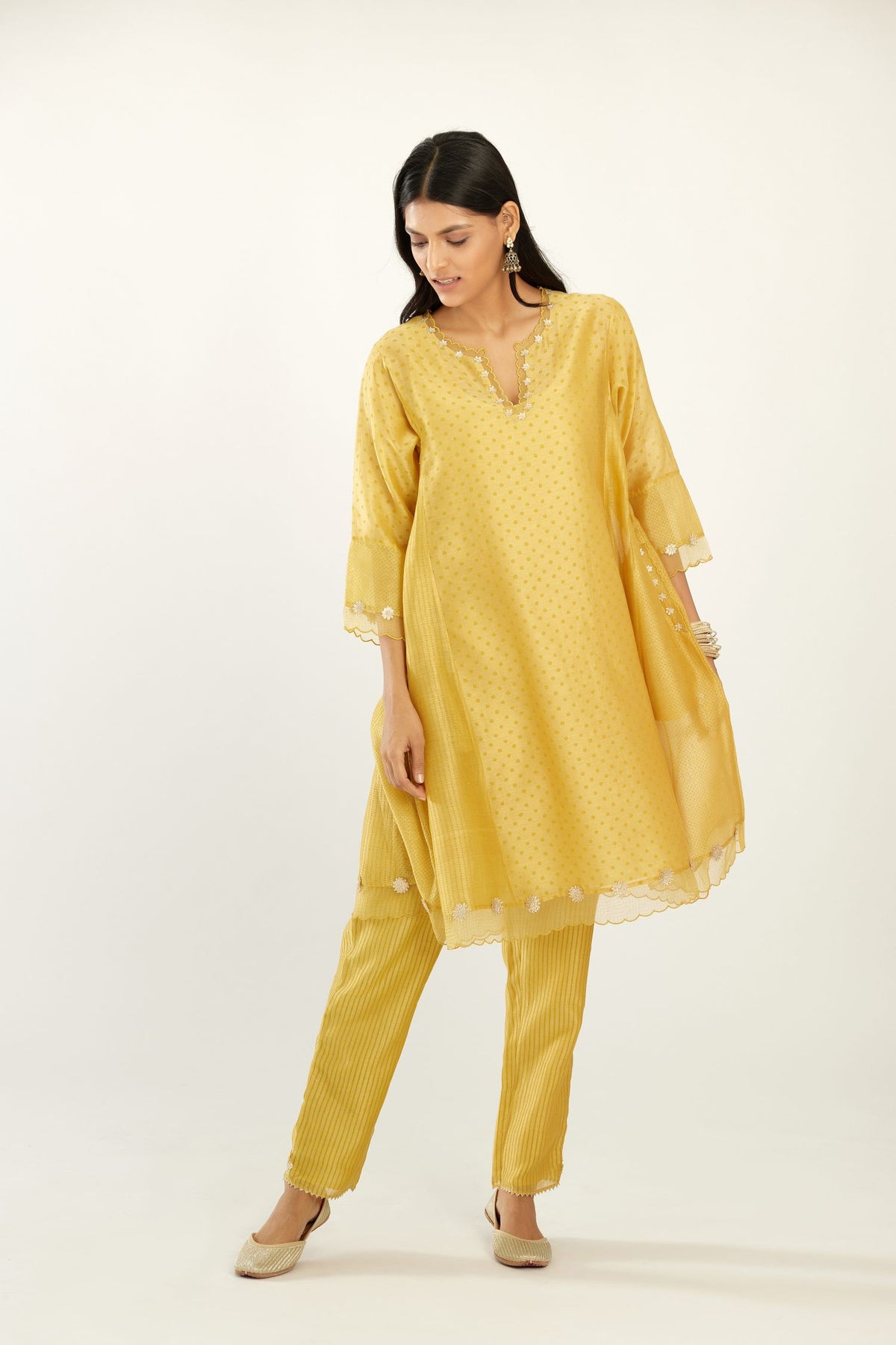 Yellow hand block printed silk chanderi easy fit short kurta set, highlighted with gota flower and scalloped organza at edges.