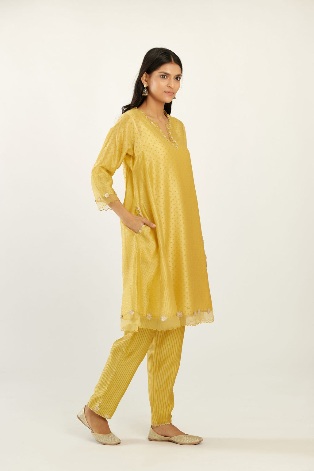 Yellow hand block printed silk chanderi easy fit short kurta set, highlighted with gota flower and scalloped organza at edges.