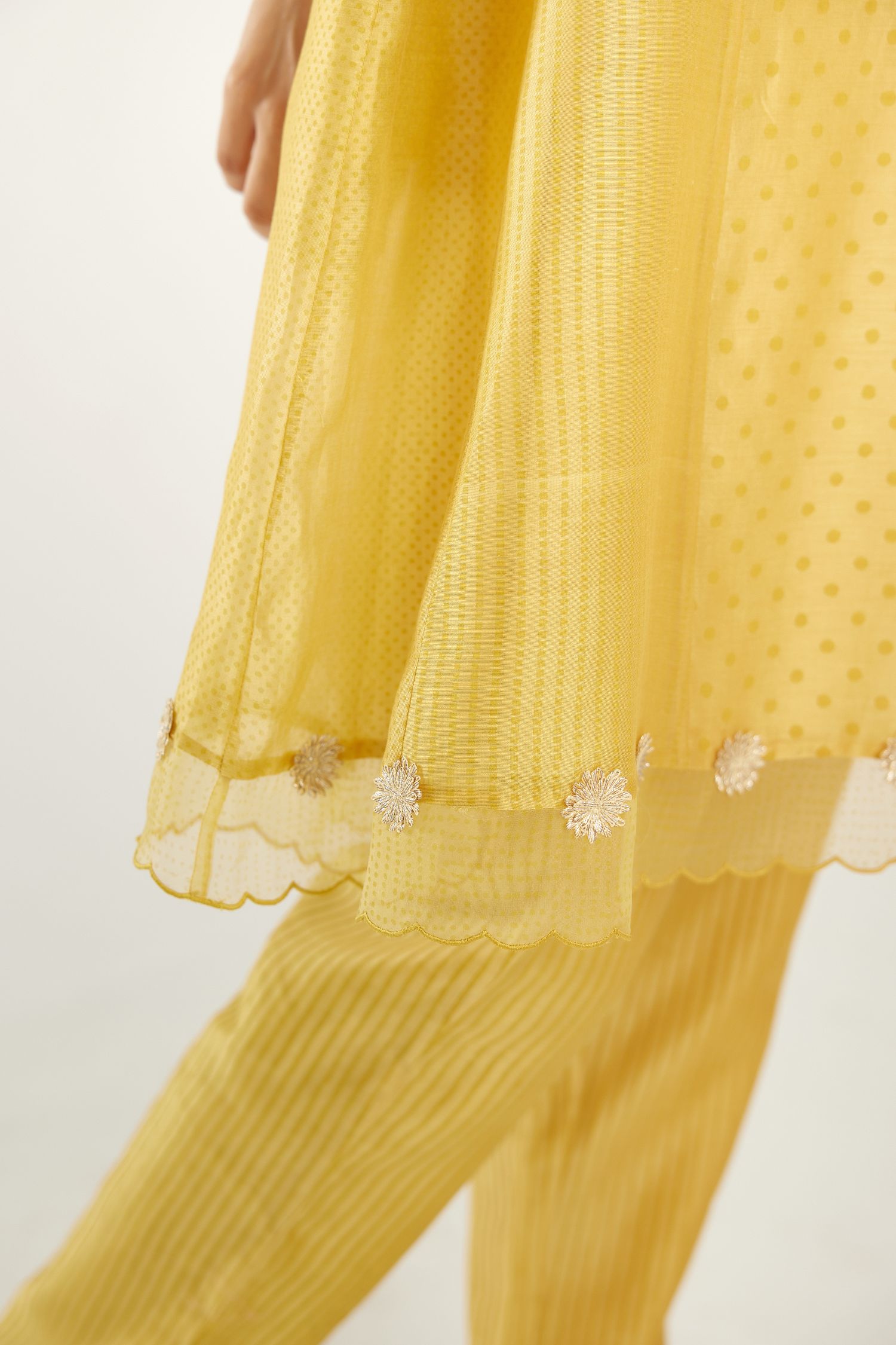 Yellow hand block printed silk chanderi easy fit short kurta set, highlighted with gota flower and scalloped organza at edges.