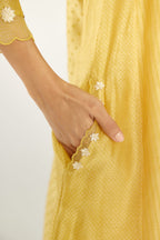 Yellow hand block printed silk chanderi easy fit short kurta set, highlighted with gota flower and scalloped organza at edges.