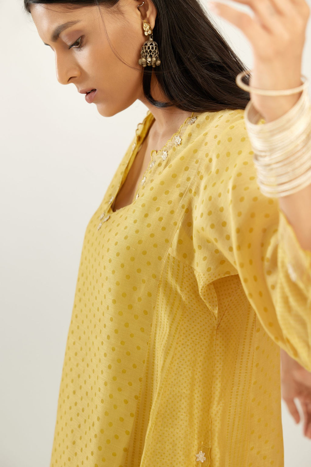 Yellow hand block printed silk chanderi easy fit short kurta set, highlighted with gota flower and scalloped organza at edges.