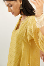 Yellow hand block printed silk chanderi easy fit short kurta set, highlighted with gota flower and scalloped organza at edges.