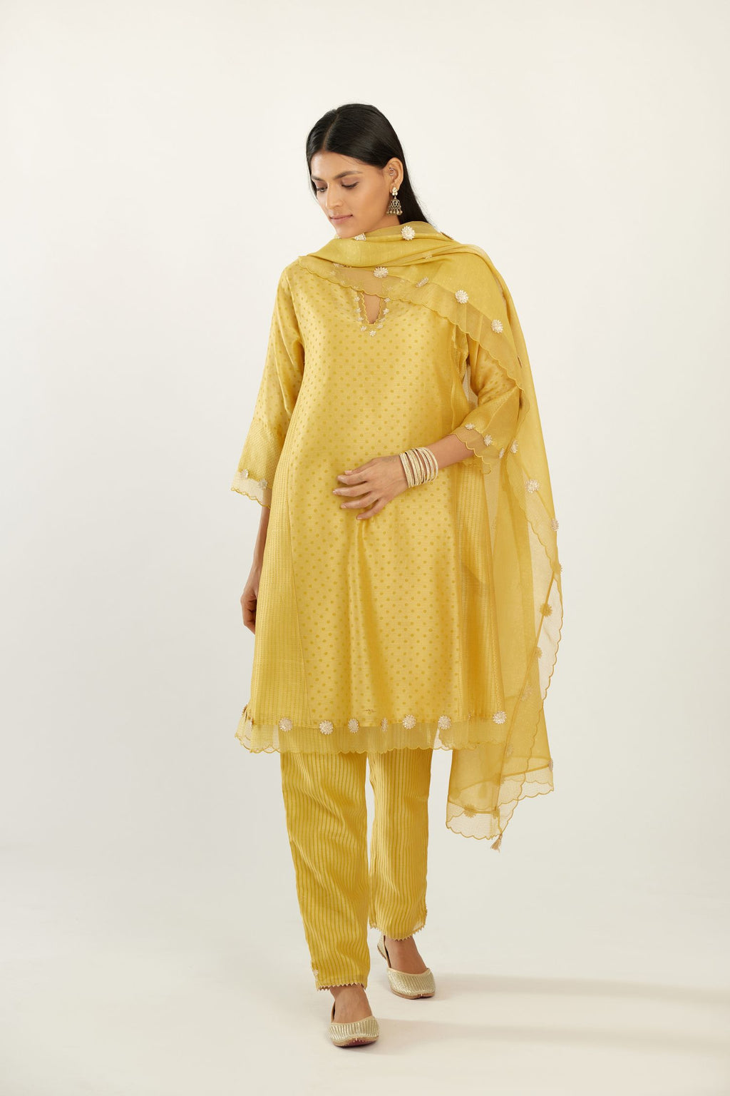 Yellow hand block printed silk chanderi easy fit short kurta set, highlighted with gota flower and scalloped organza at edges.
