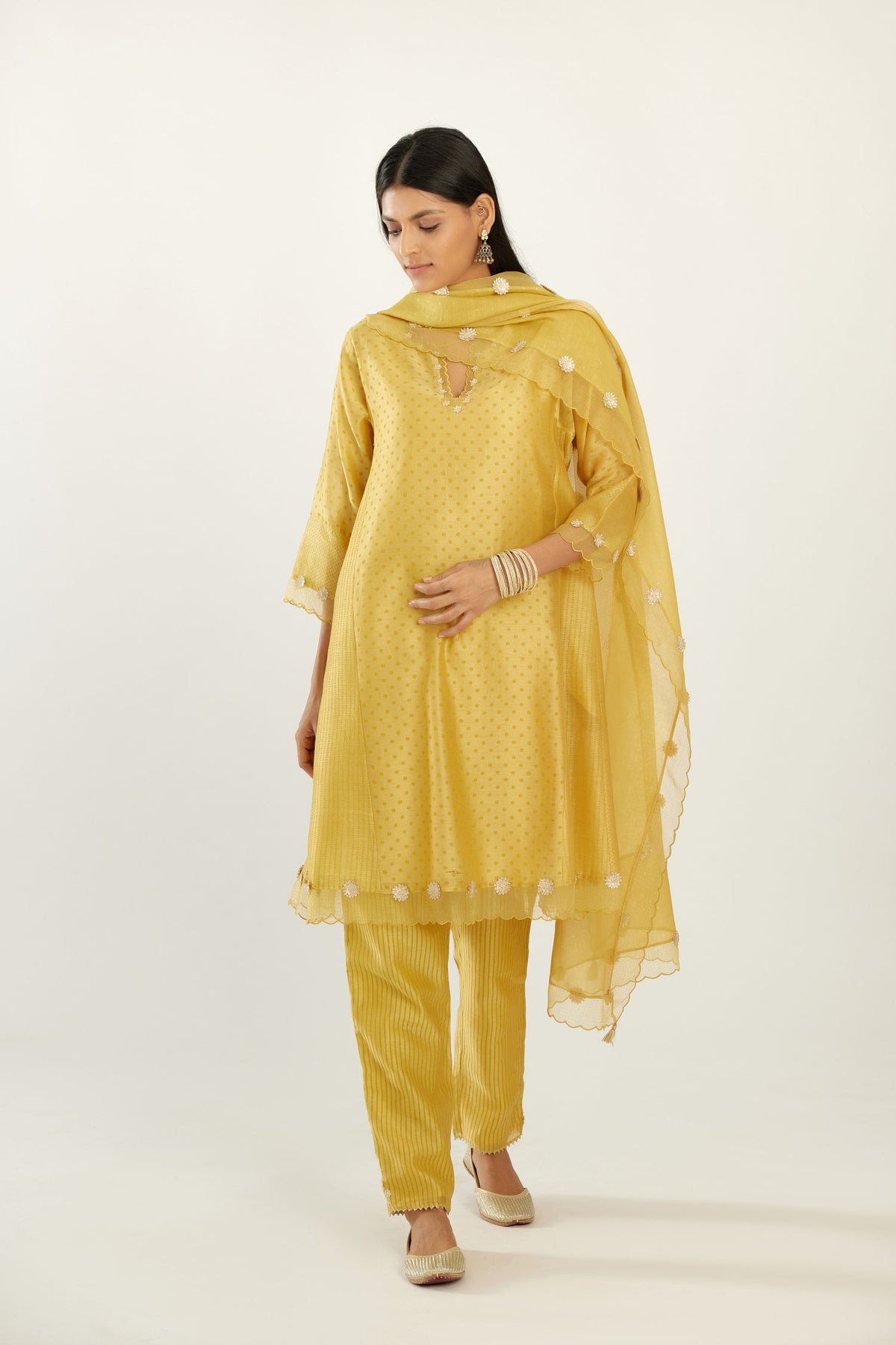 Yellow hand block printed silk chanderi easy fit short kurta set, highlighted with gota flower and scalloped organza at edges.