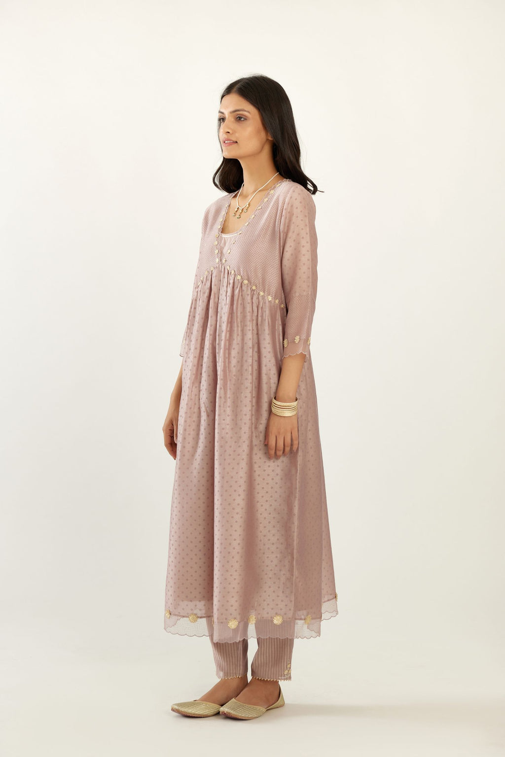Lilac hand block printed V neck gathered kurta set, highlighted with gota flower embroidery and scalloped organza at edges.
