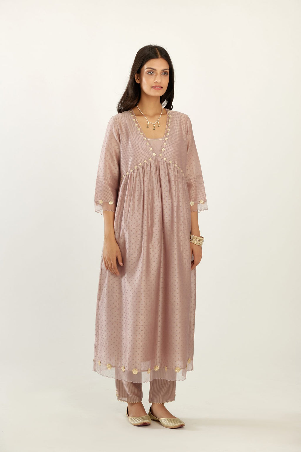 Lilac hand block printed V neck gathered kurta set, highlighted with gota flower embroidery and scalloped organza at edges.
