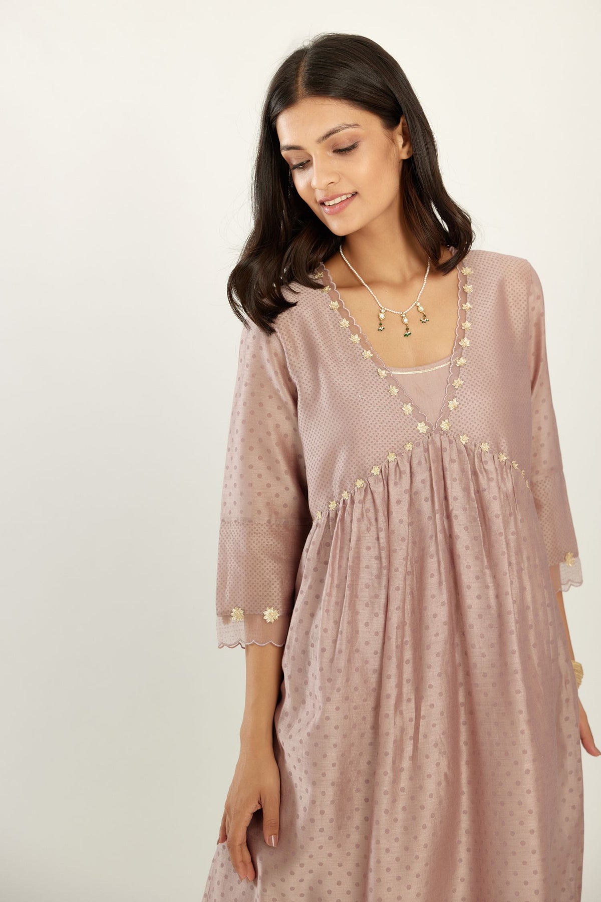 Lilac hand block printed V neck gathered kurta set, highlighted with gota flower embroidery and scalloped organza at edges.