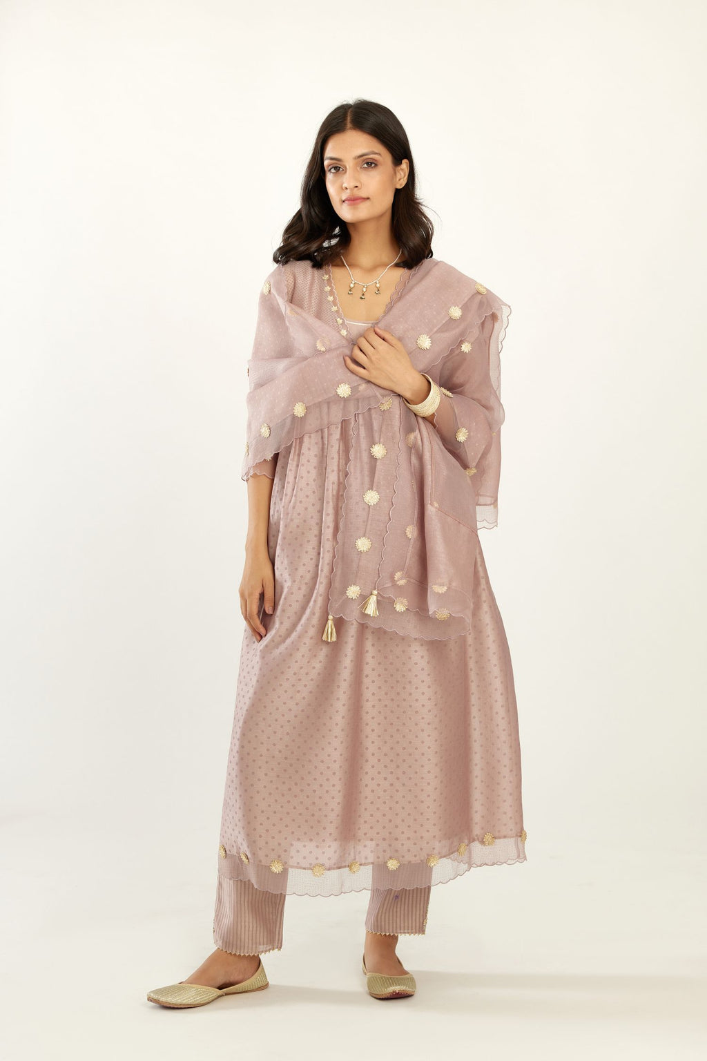 Lilac hand block printed V neck gathered kurta set, highlighted with gota flower embroidery and scalloped organza at edges.
