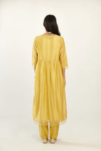 Yellow hand block printed V neck gathered kurta set, highlighted with gota flower embroidery and scalloped organza at edges.