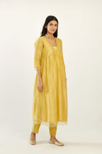 Yellow hand block printed V neck gathered kurta set, highlighted with gota flower embroidery and scalloped organza at edges.