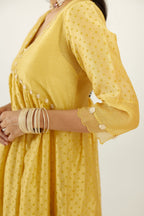 Yellow hand block printed V neck gathered kurta set, highlighted with gota flower embroidery and scalloped organza at edges.