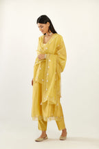 Yellow hand block printed V neck gathered kurta set, highlighted with gota flower embroidery and scalloped organza at edges.