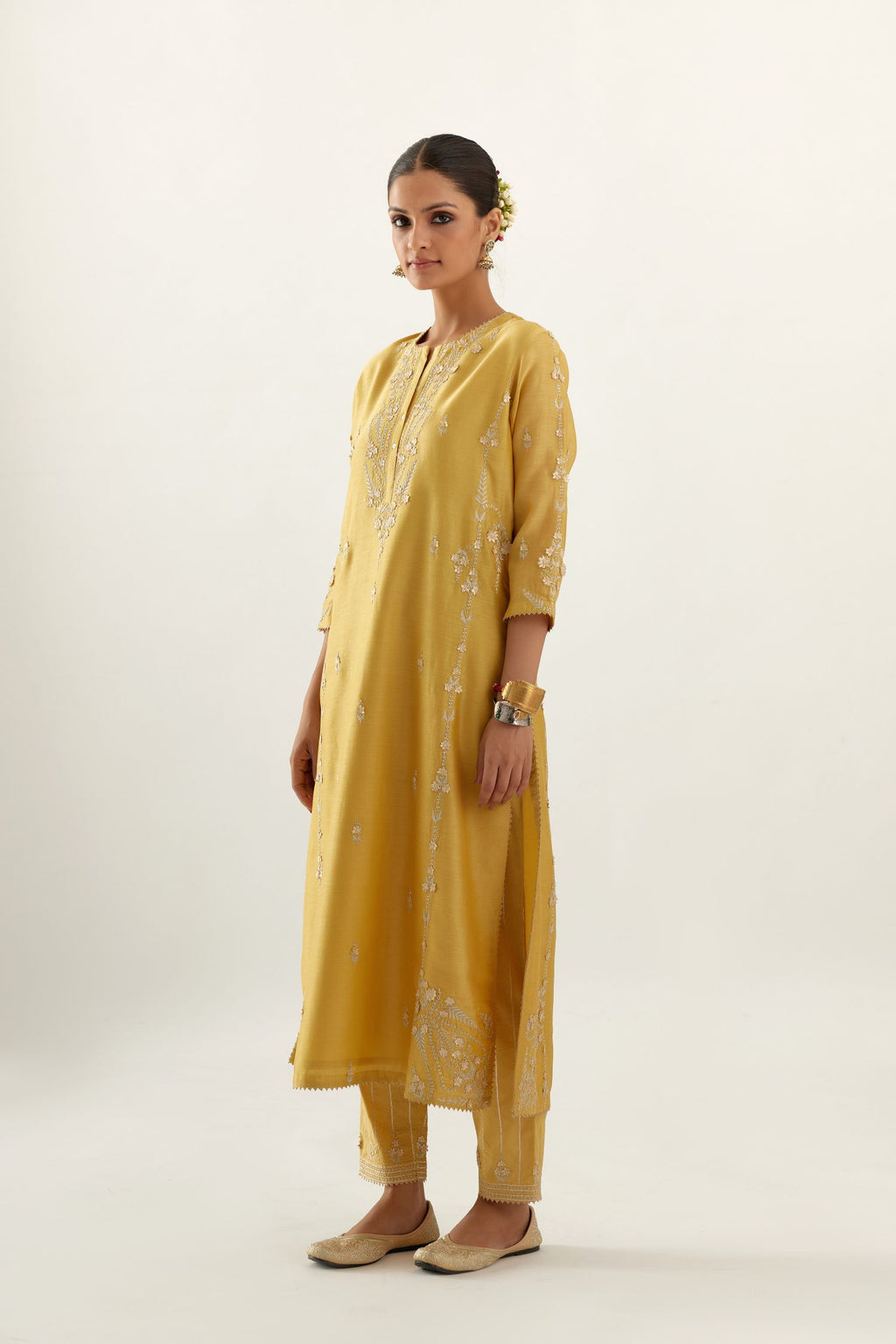 Yellow silk chanderi straight kurta set with button placket neckline, highlighted with all-over gold gota and zari embroidery.