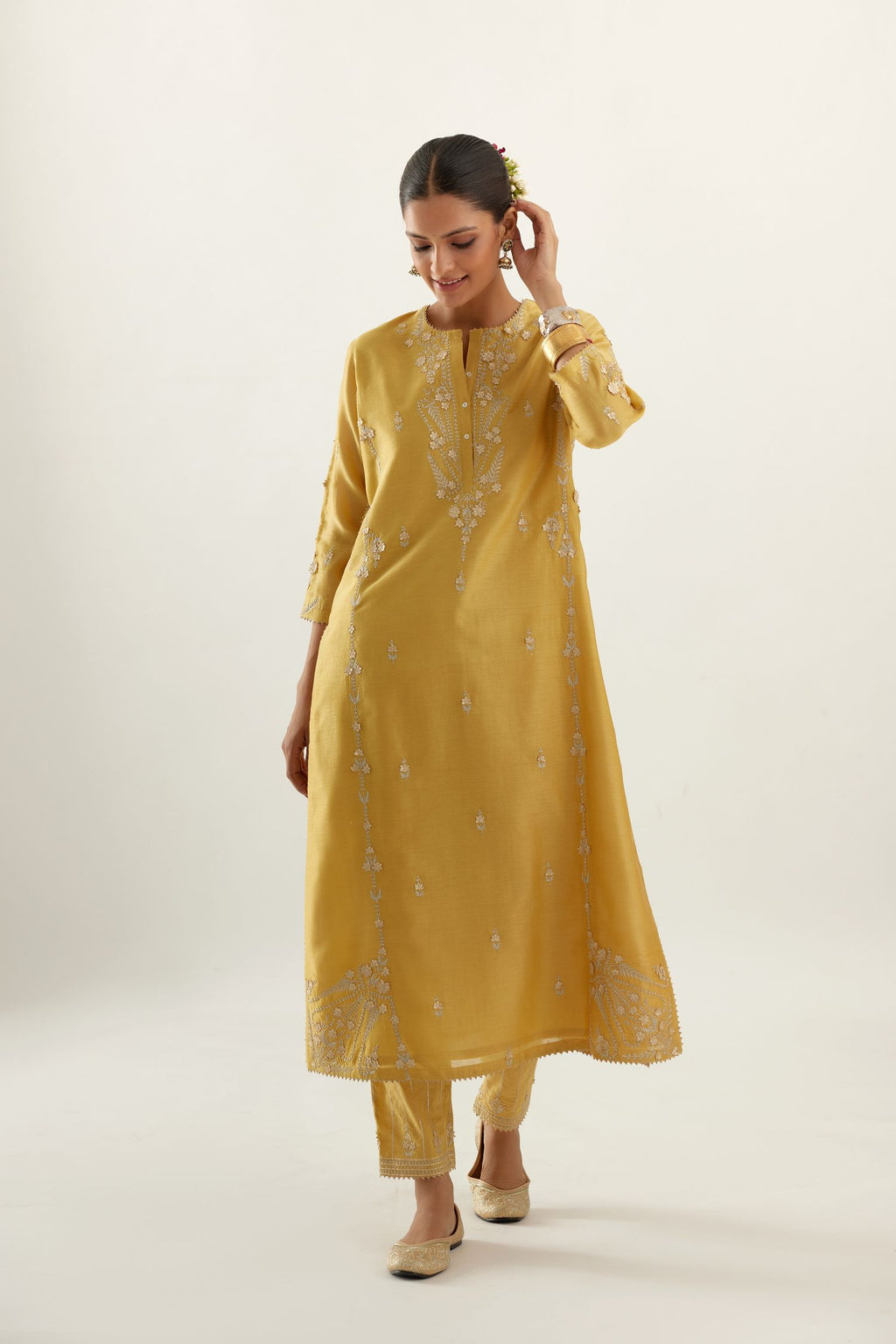 Yellow silk chanderi straight kurta set with button placket neckline, highlighted with all-over gold gota and zari embroidery.