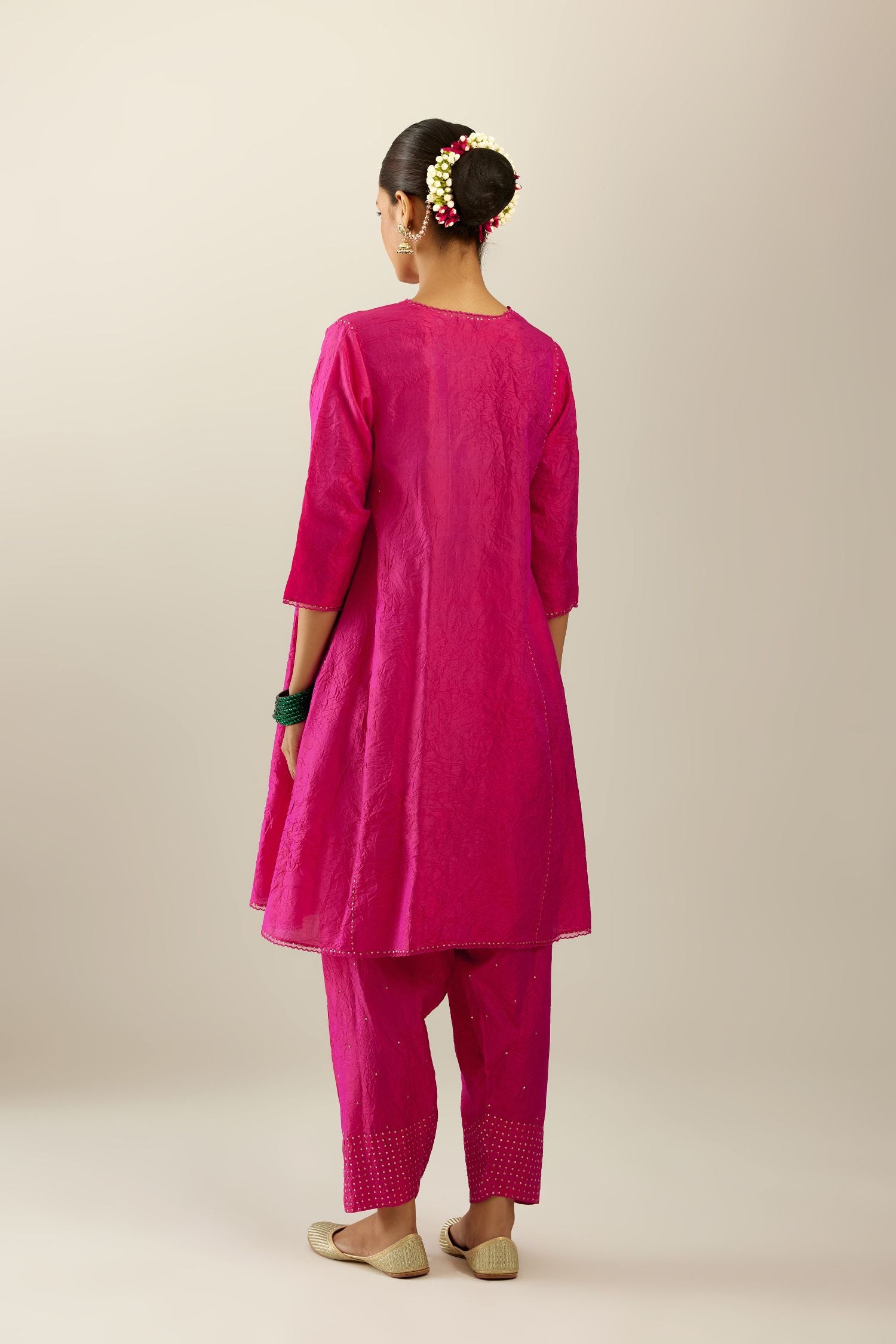 Silk hand crushed short kalidar kurta set with button placket, highlighted with gold sequins and embroidered scalloped organza at edges.