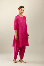 Silk hand crushed short kalidar kurta set with button placket, highlighted with gold sequins and embroidered scalloped organza at edges.